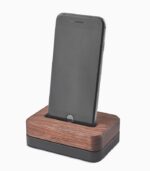 A phone is sitting on the wooden stand.