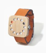 A wooden watch with orange leather strap.